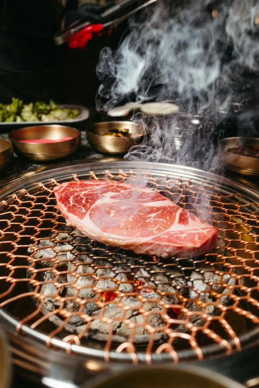 steak on a bbq with smoke coming out from it