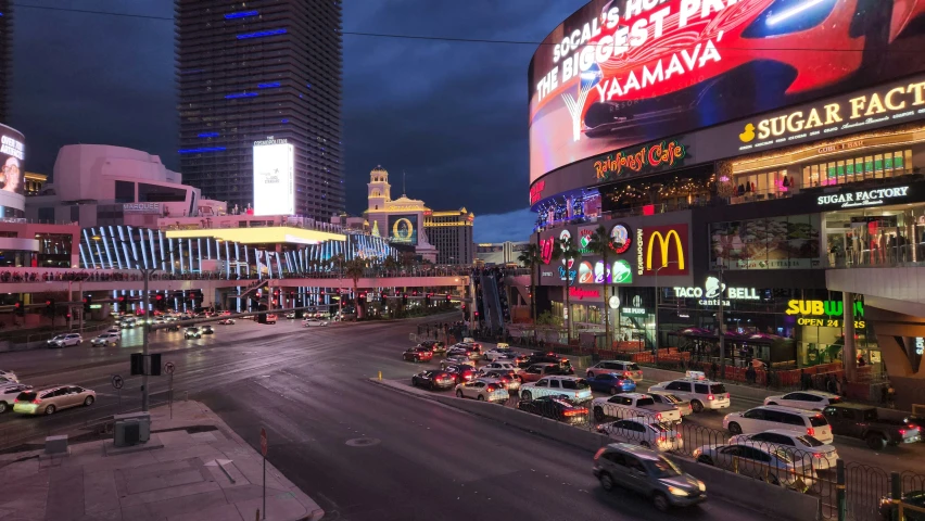 the busy street in front of a casino in the evening