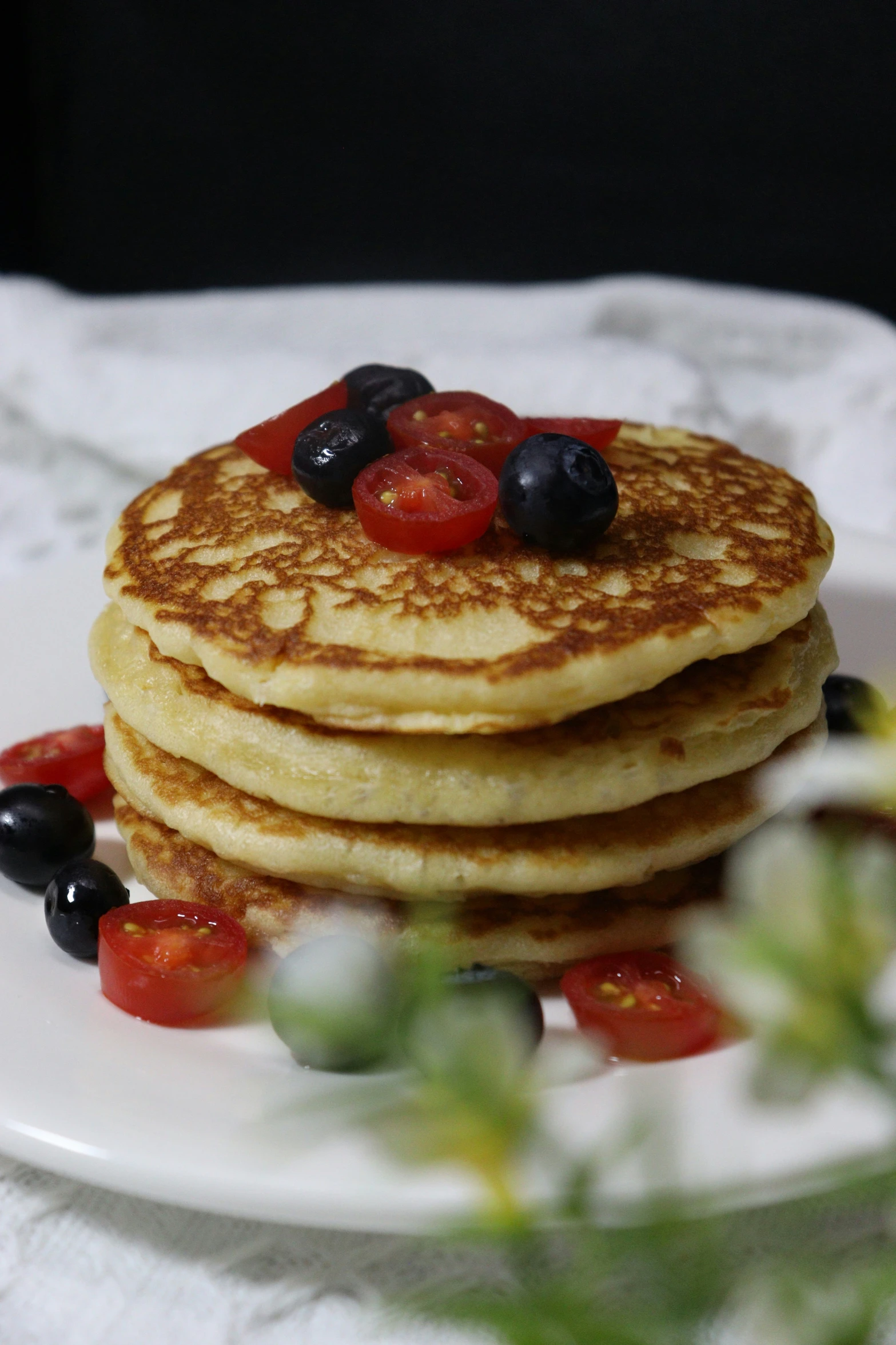 there are many pancakes with berries on top of it