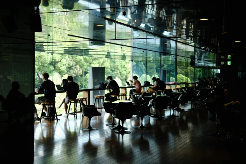 a dimly lit restaurant with lots of tables and people sitting around