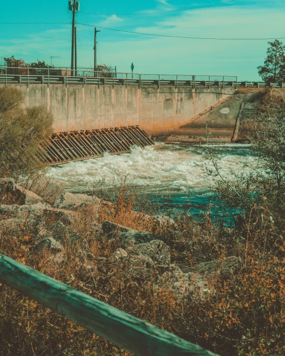 an old rusty bridge sits over the water