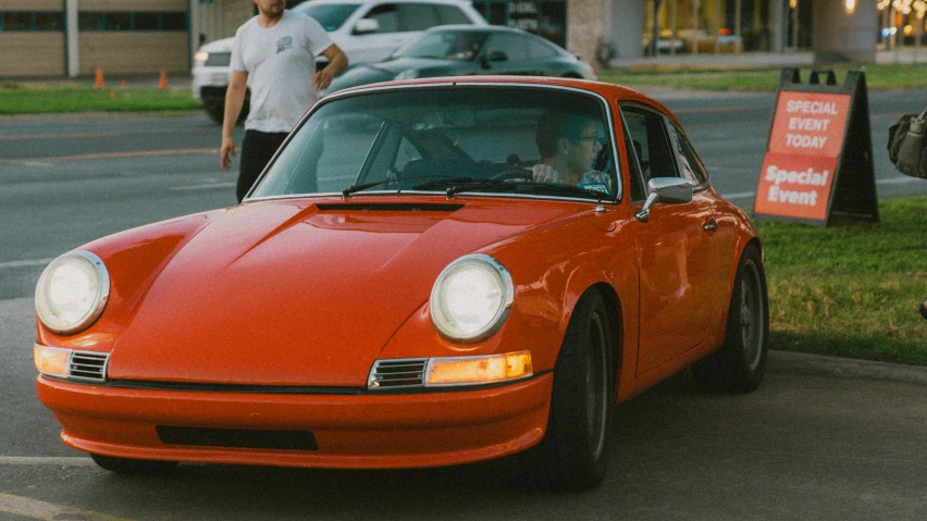 a very red car parked in front of a building