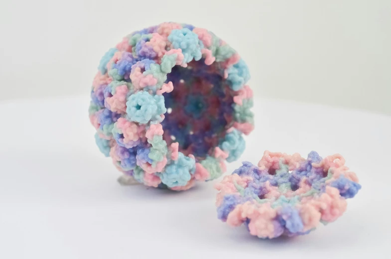 an ornament made with tiny crochet flowers and yarn