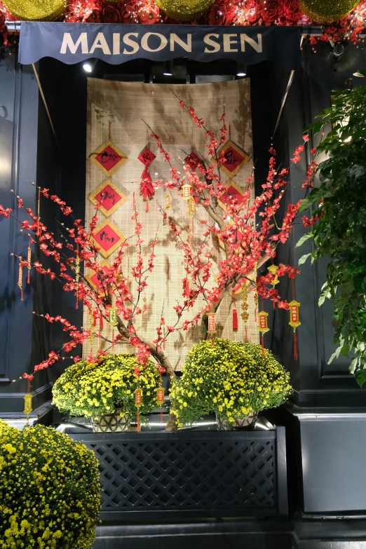 a building covered in decorations next to shrubs