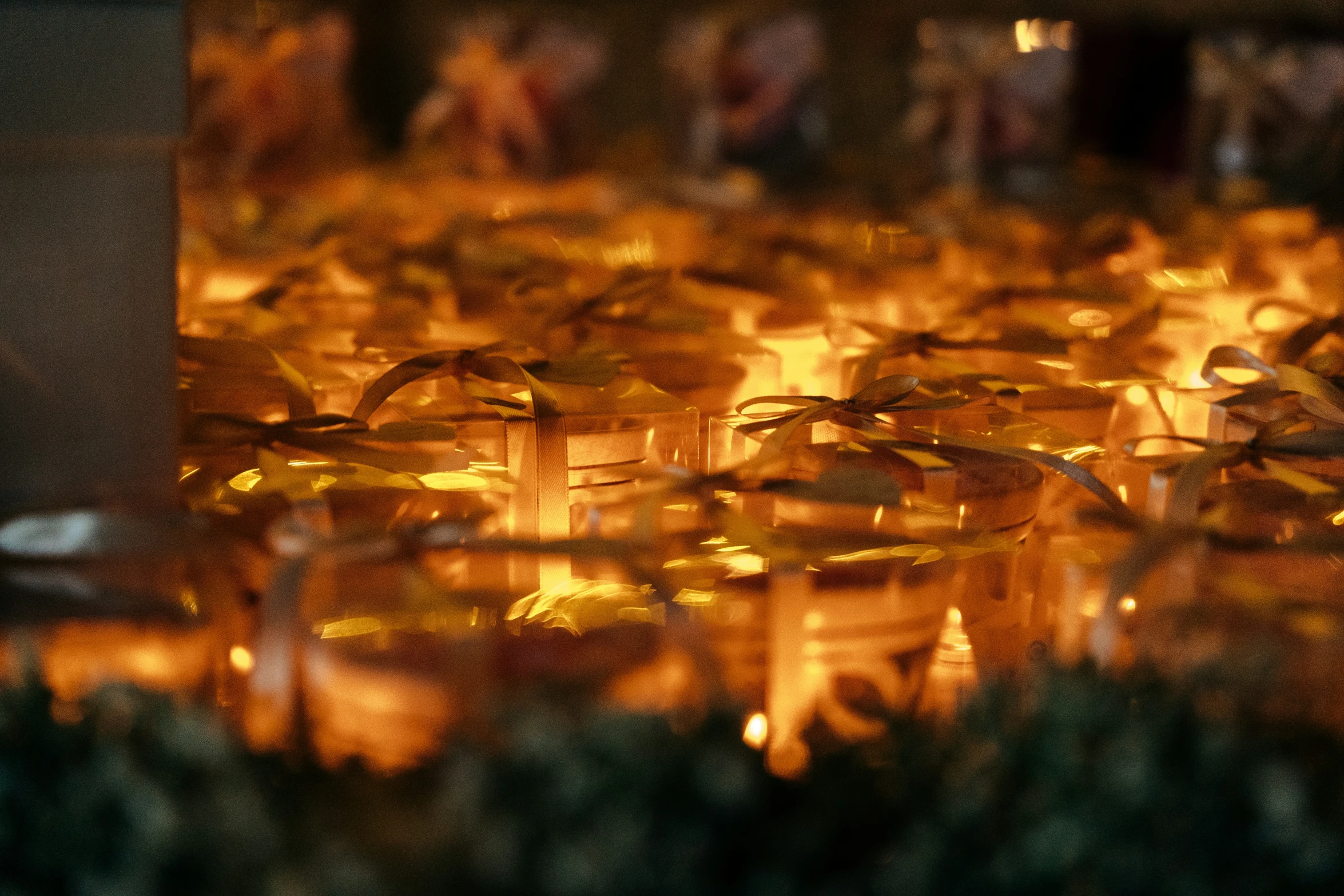 a blurred view of candles in a glass container