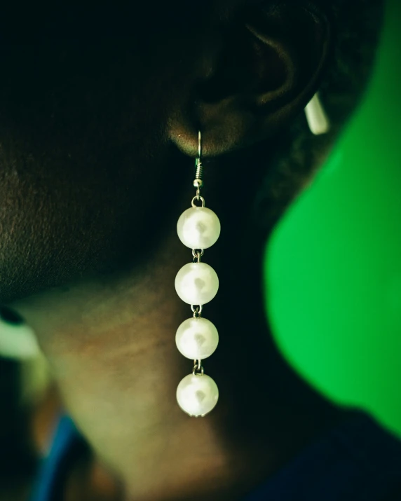 the earrings have pearl beads and dangling drops