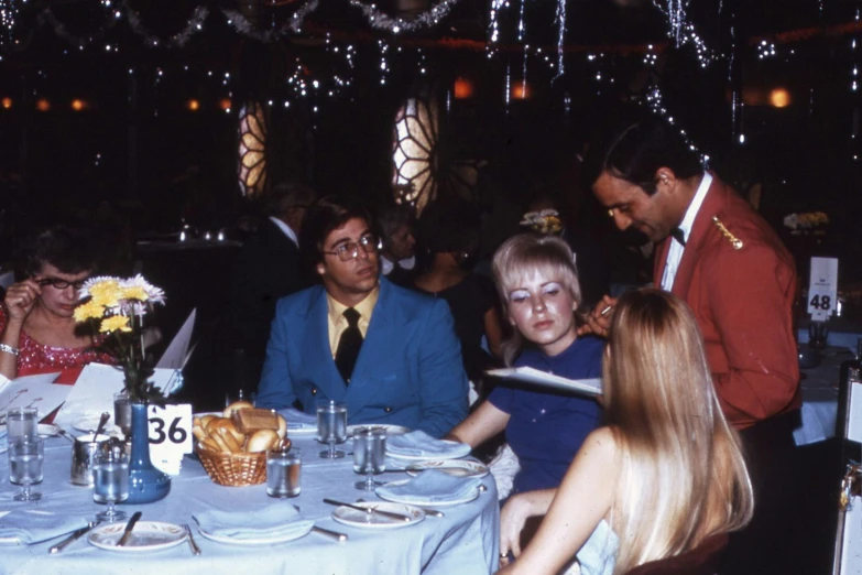 a group of people sitting around a table at a party