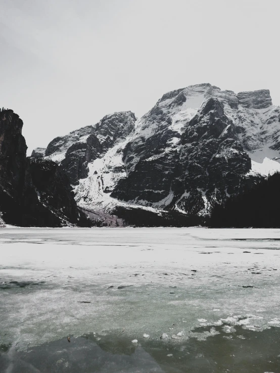 an ice lake with mountains in the background