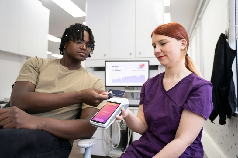 two people in a lab with cell phones and monitors