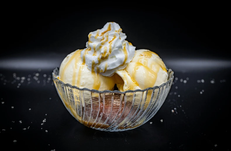 three ice cream covered dessert in a bowl on a table