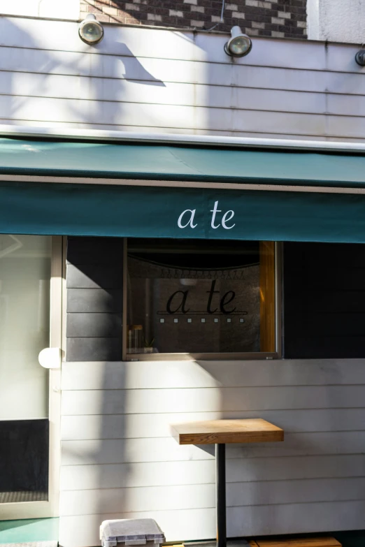 a bench is sitting outside of a shopfront window