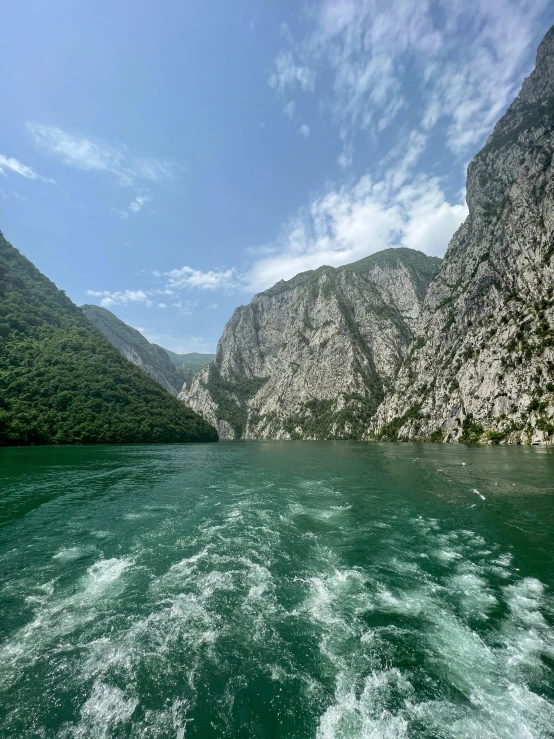 water moving between mountains on the waterside