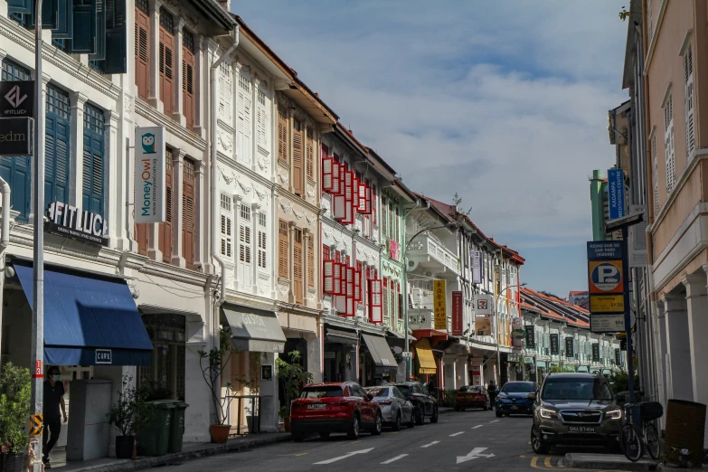 cars are lined up and parked in a row near an empty street