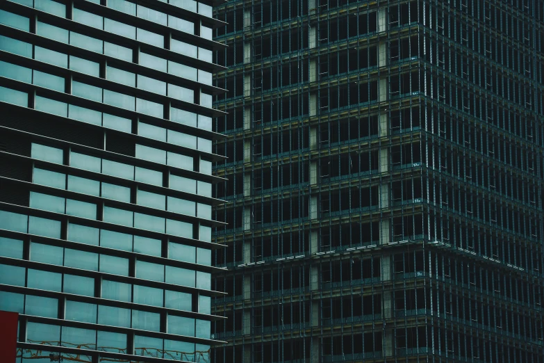 a tall building with one being lit up at night