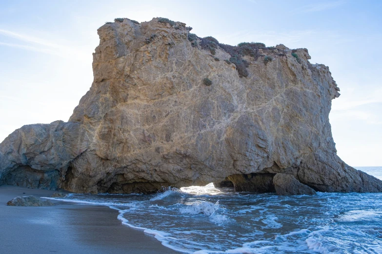 the rock formation is near the beach shore