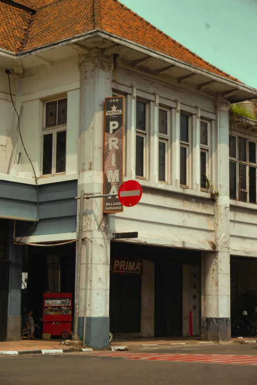 a building with some signs on the front and an upside down stop sign on the front