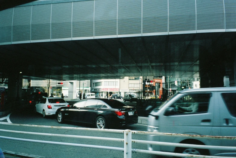 several cars in the street behind a building