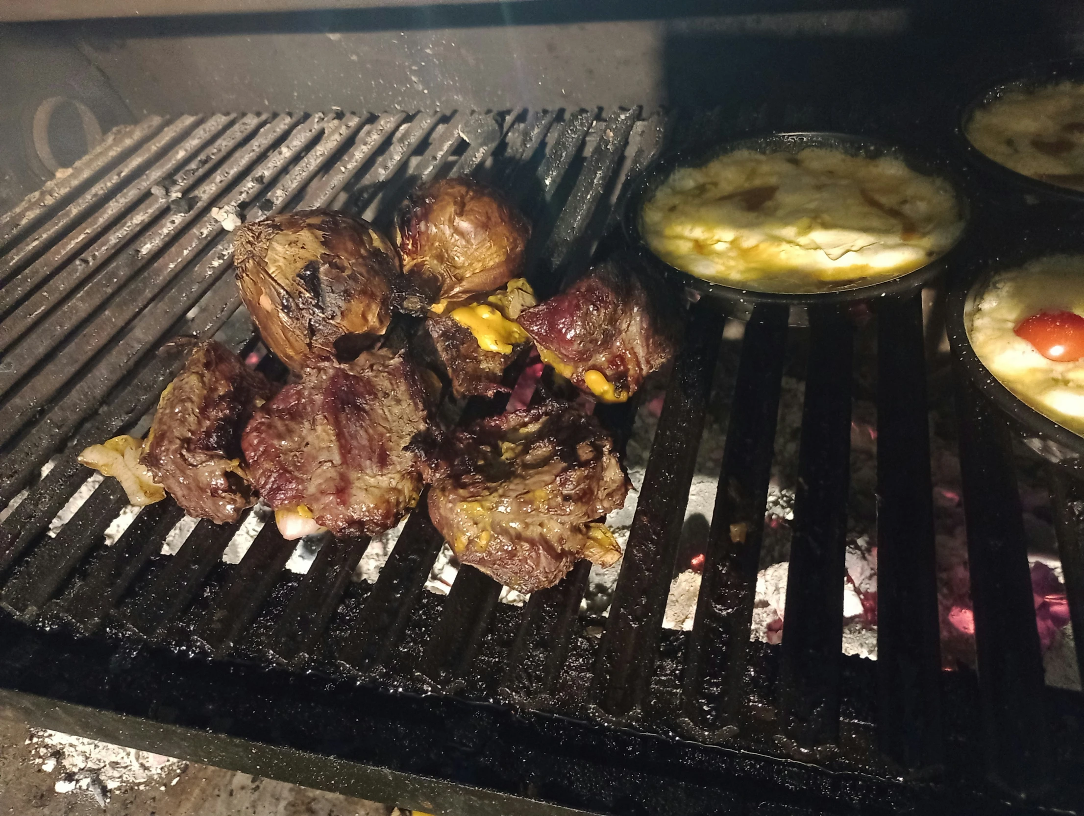 a grill with a grilling rack on it and different cooking items on the grill