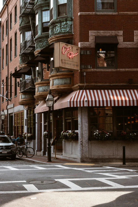 a street corner with parked cars on the side of it