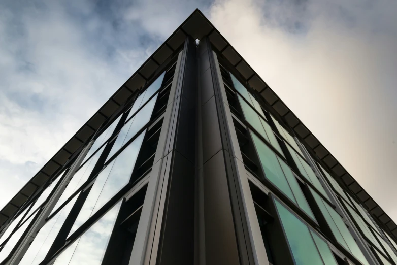 tall building with lots of windows on a cloudy day