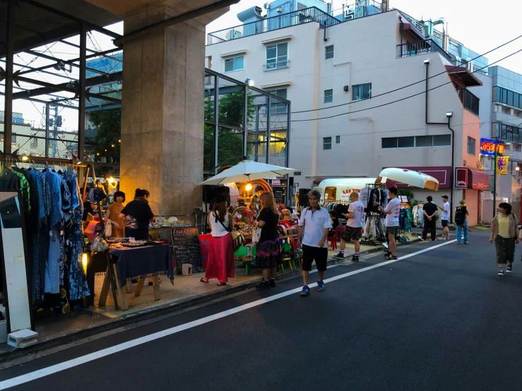 people are on the sidewalk at an event