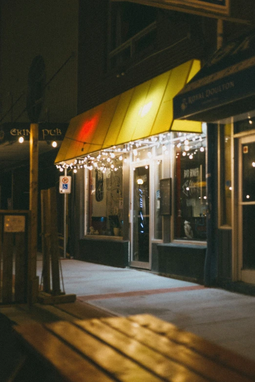 the night view of the front of a restaurant with lights and decorations