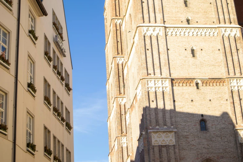 a view looking up at the tall buildings with windows