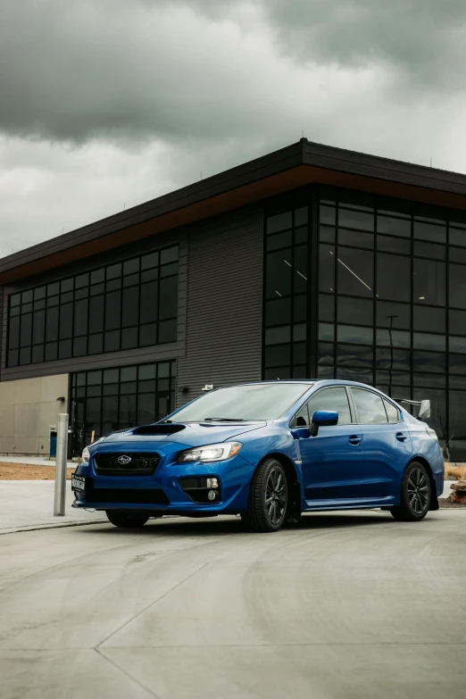 a blue car is parked outside a building