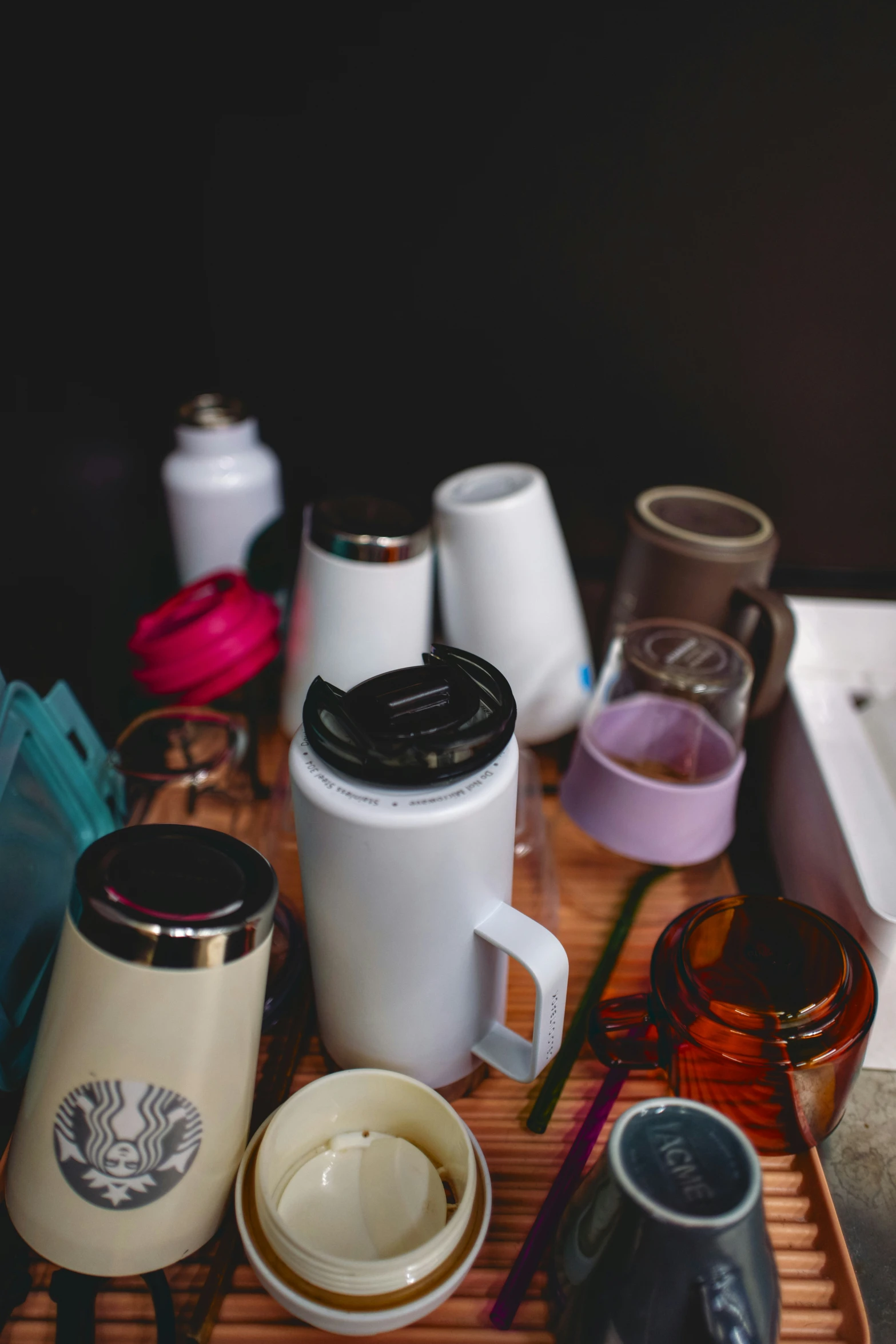 there is a bamboo tray that has cups and other items on it