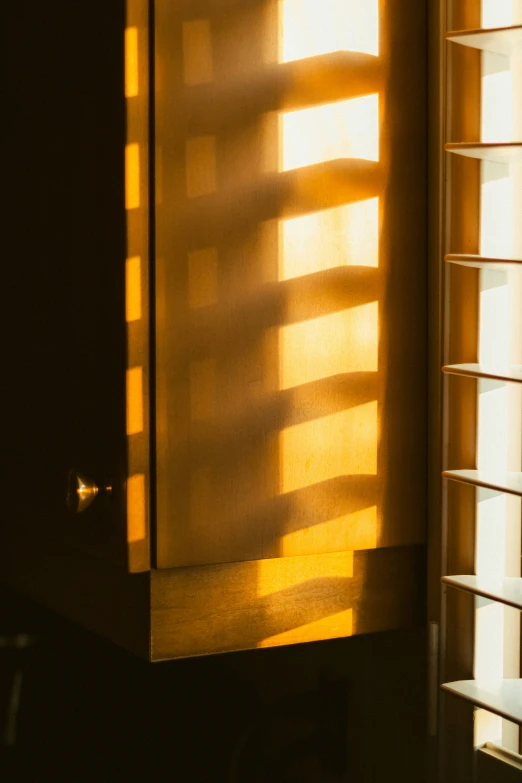 the inside of an empty room with light coming through the blinds