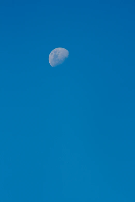 the plane is flying under a blue sky