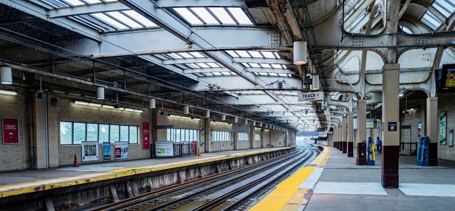 a train station with train tracks and many windows