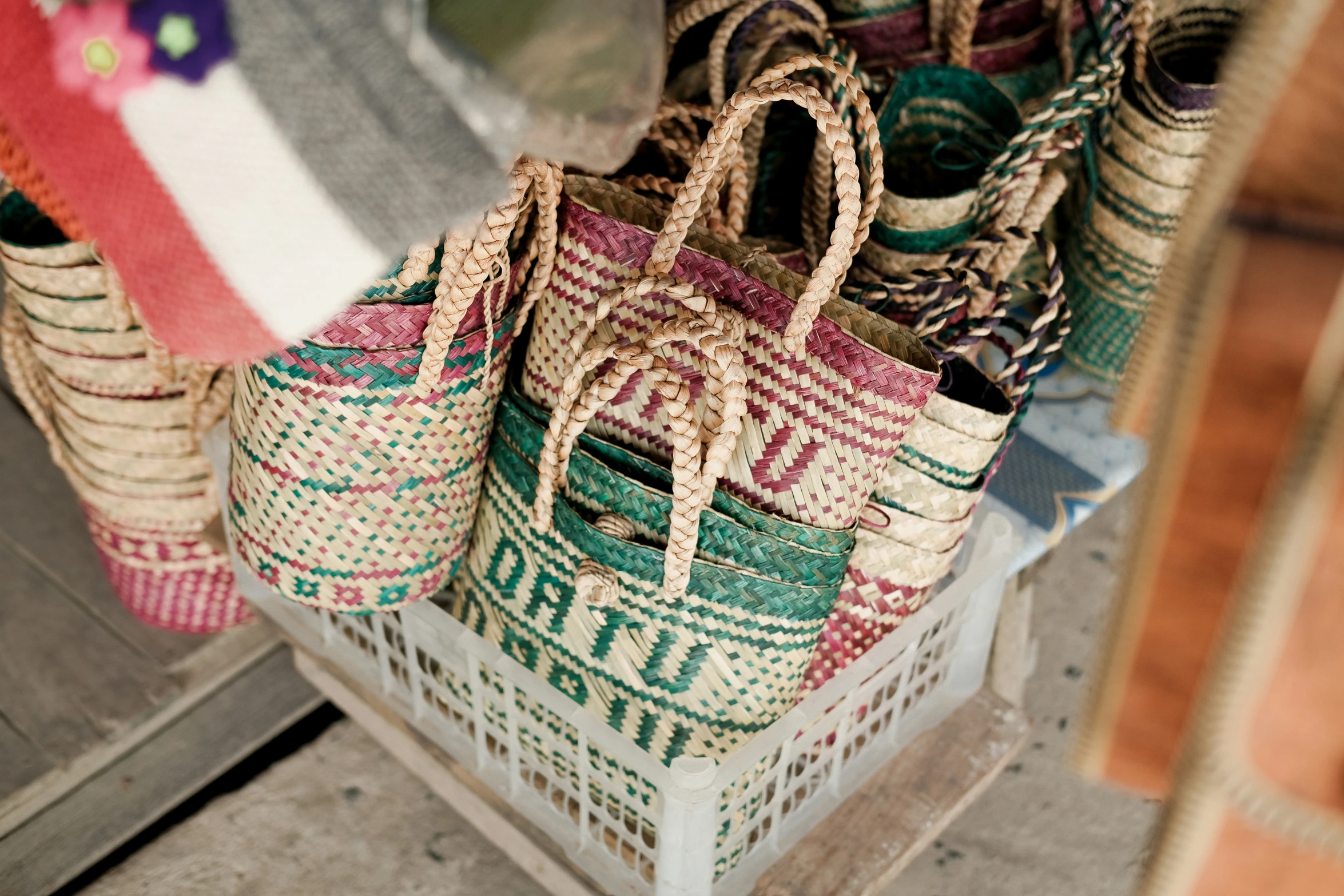 multi - colored handbags are stacked on the floor in an indian weaving pattern