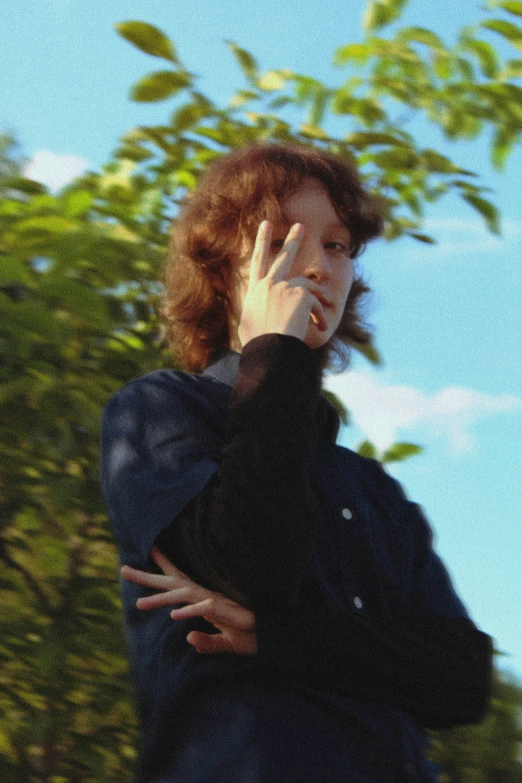 woman with red hair and black jacket and black jacket talking on cellphone