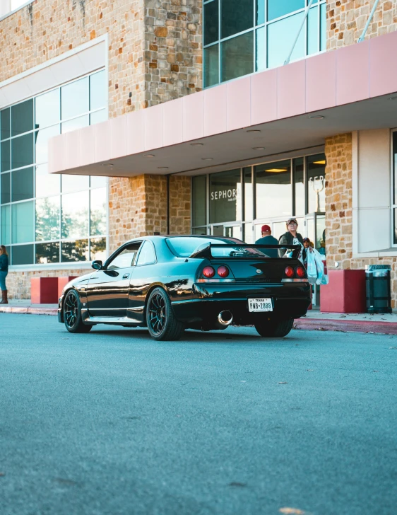 a very cute black sports car by some people