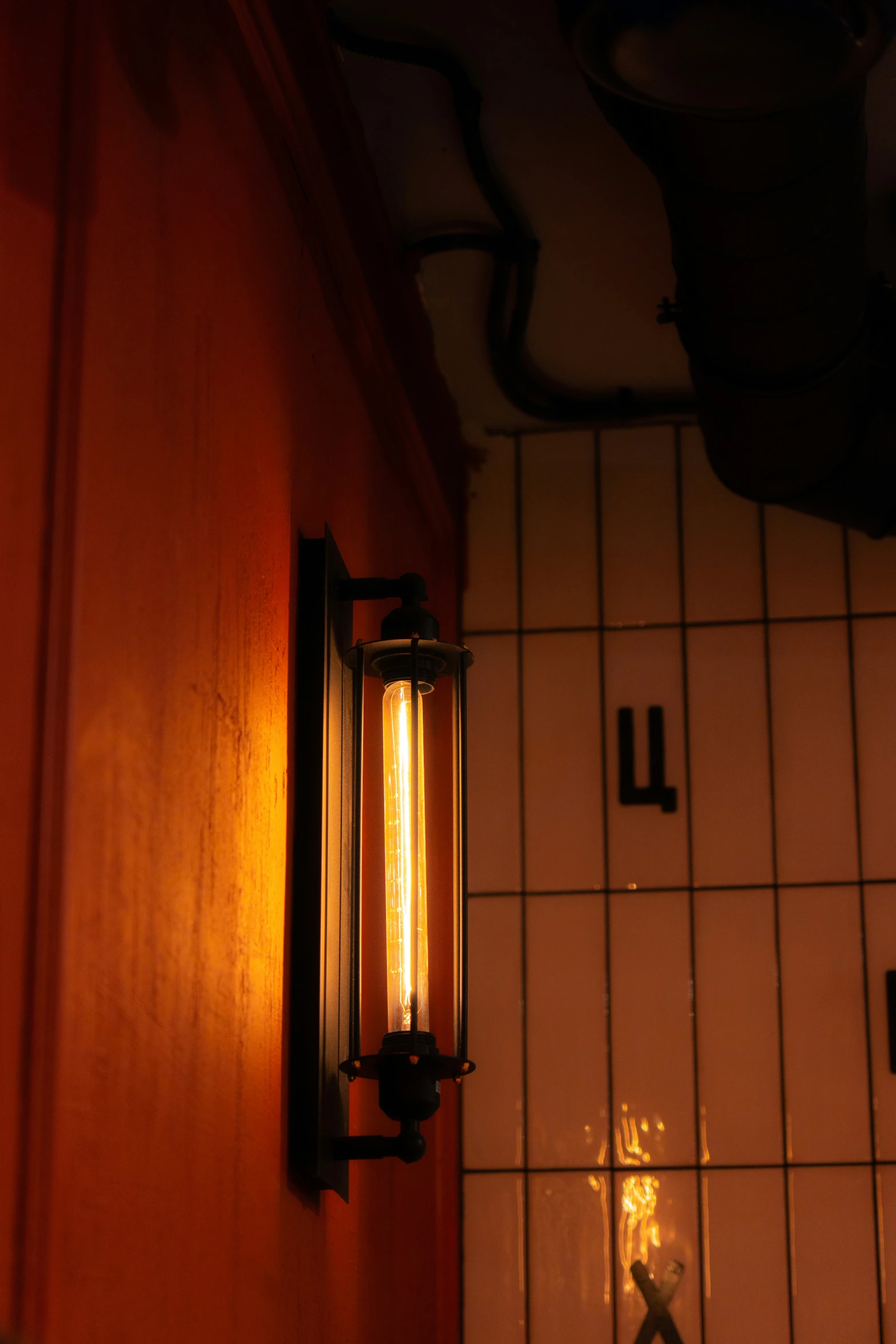 a bathroom wall light on a tiled wall