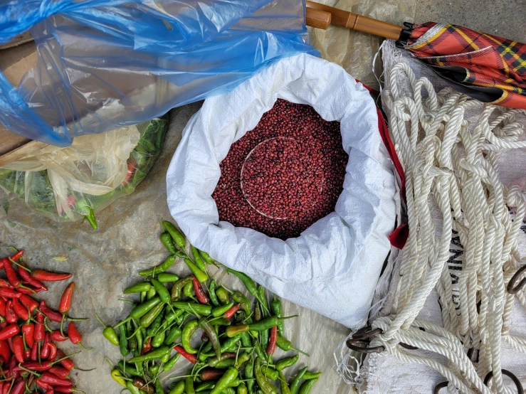 a bag filled with bean next to assorted vegetables