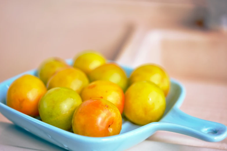 a blue bowl filled with different colored fruits