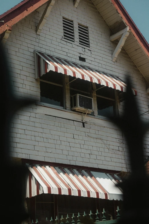 a large white brick building with an awning