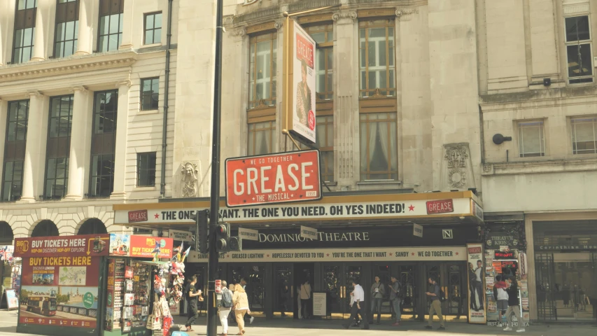 the people are standing outside a street show