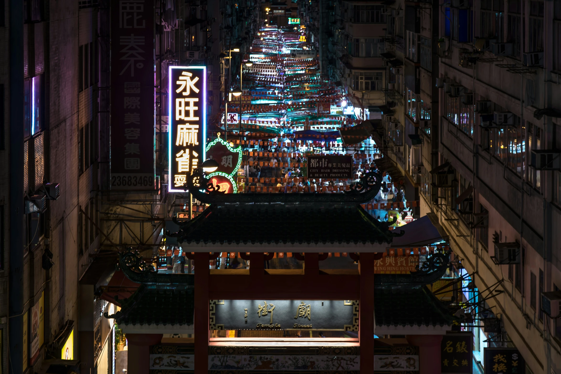 a long narrow street lit up at night