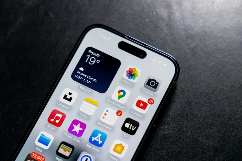 an iphone sitting on top of a table with icons