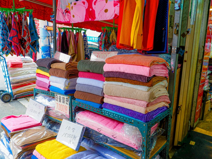 a pile of towels on display in front of a store