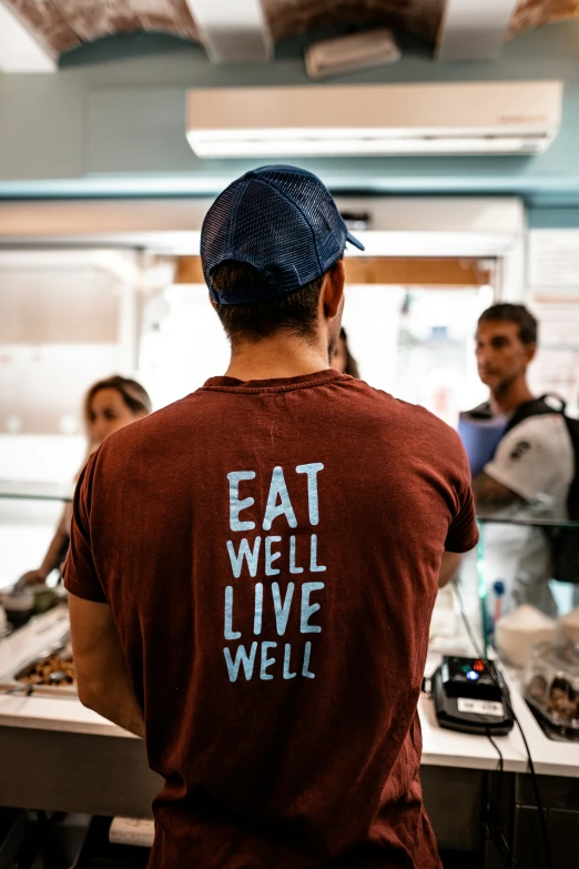 a man is wearing a t - shirt that says eat well live well