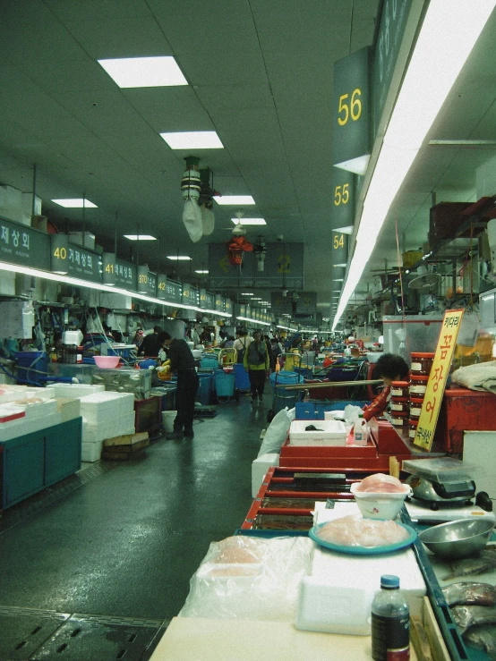 some people shops in an industrial store with customers walking past