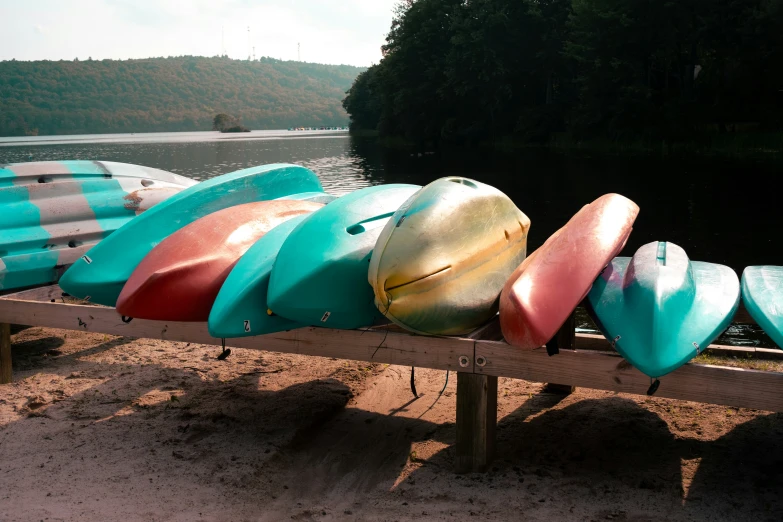 there is a bench with various colored surf boards on it