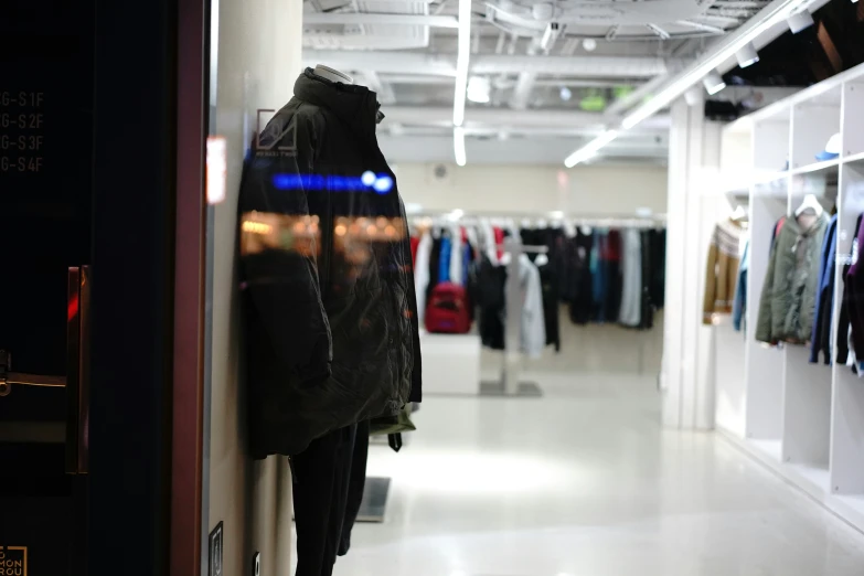 a long white hallway with several clothes on a line