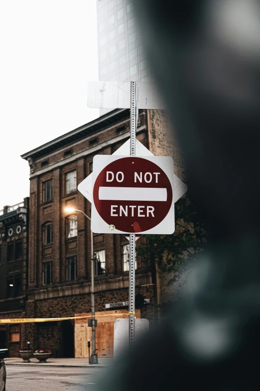 a sign showing don't enter and do not enter on a post