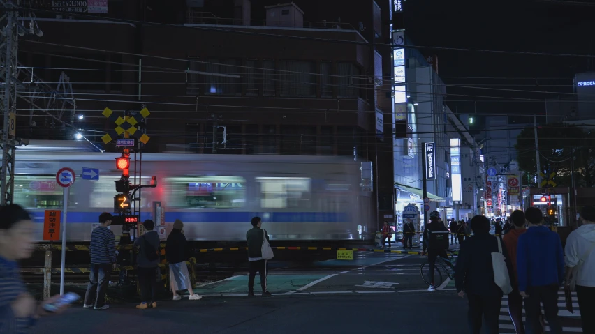 there is a train at the platform near many people