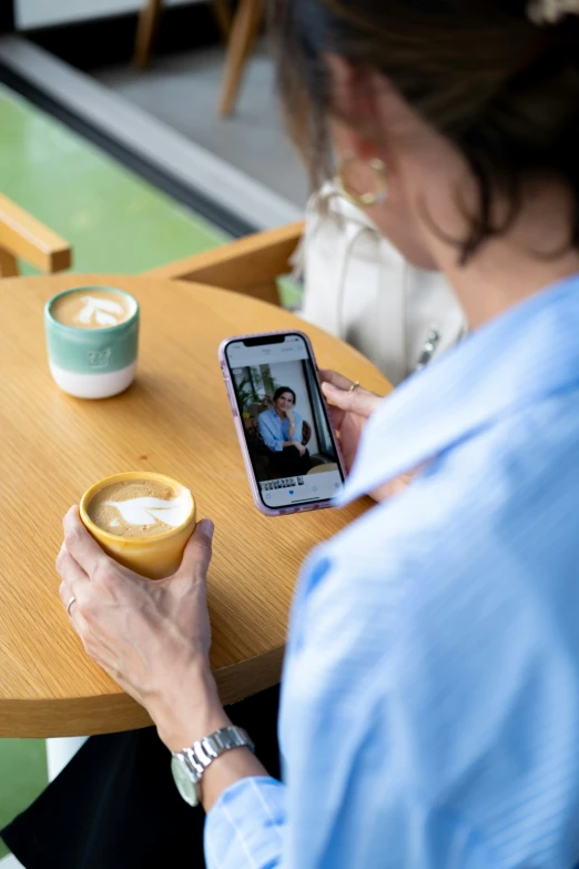 a lady is taking a selfie at the table